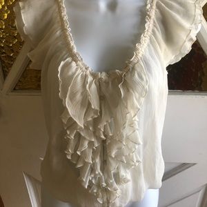 Cream colored ruffled sleeveless blouse